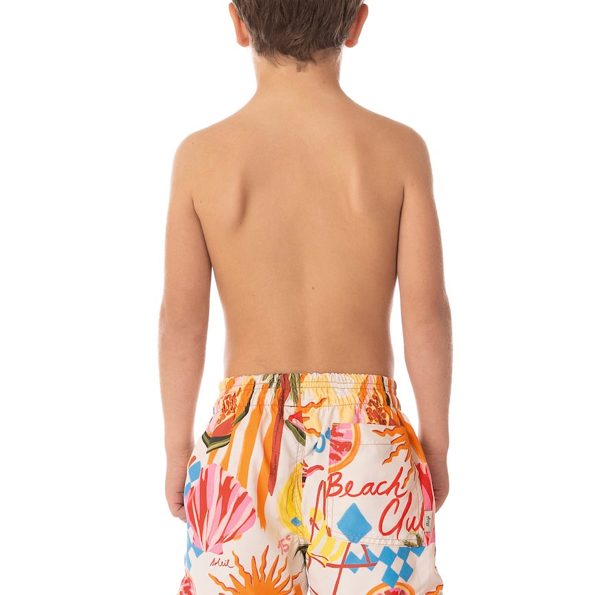 Back of child wearing colorful floral swim shorts with 'Beach Club' text on a white background