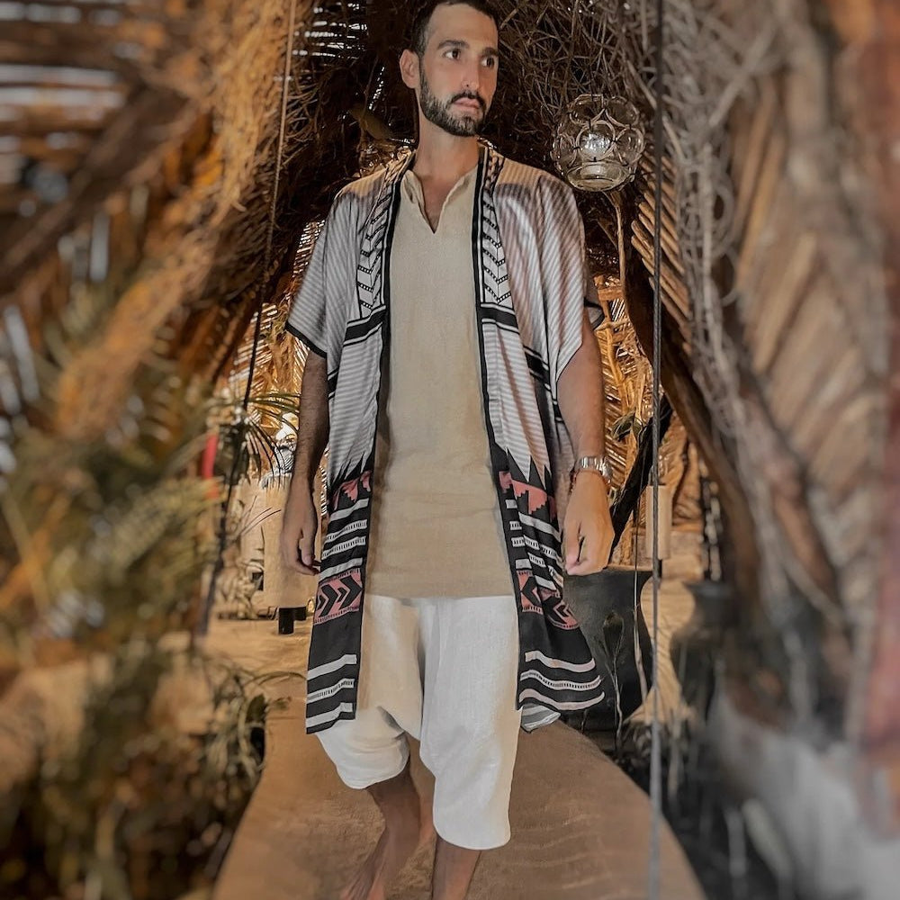 Man wearing the Apache Kimono from Plisse over shorts and a shirt. 