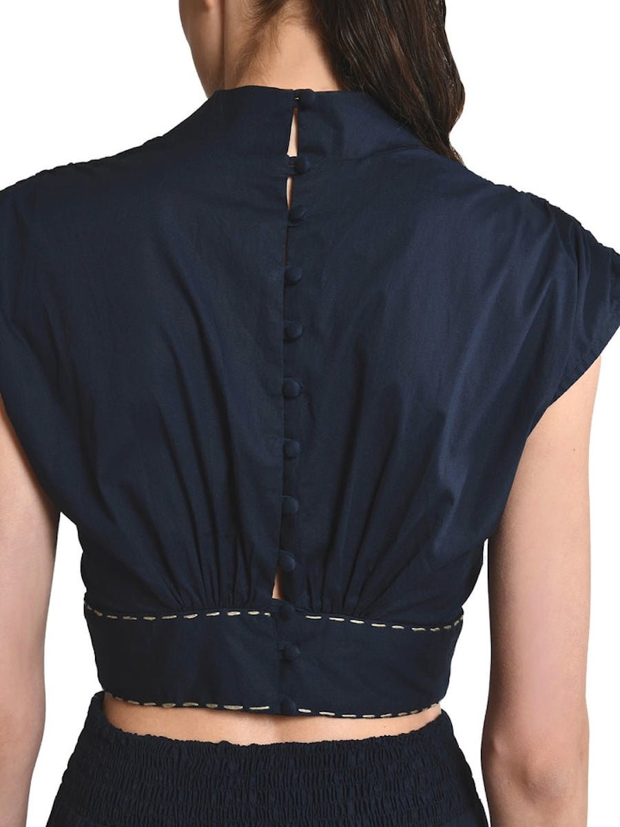 Bea Blouse in Black with embroidered gold stitching around waist, mock neck, with back lined buttons and short sleeves