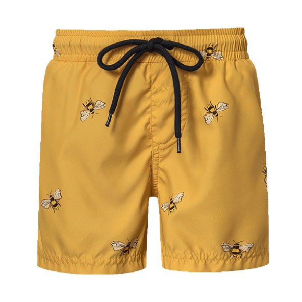 Adorable yellow swim trunks with a bee pattern. They have a black drawstring. The shorts are shown over a white background.