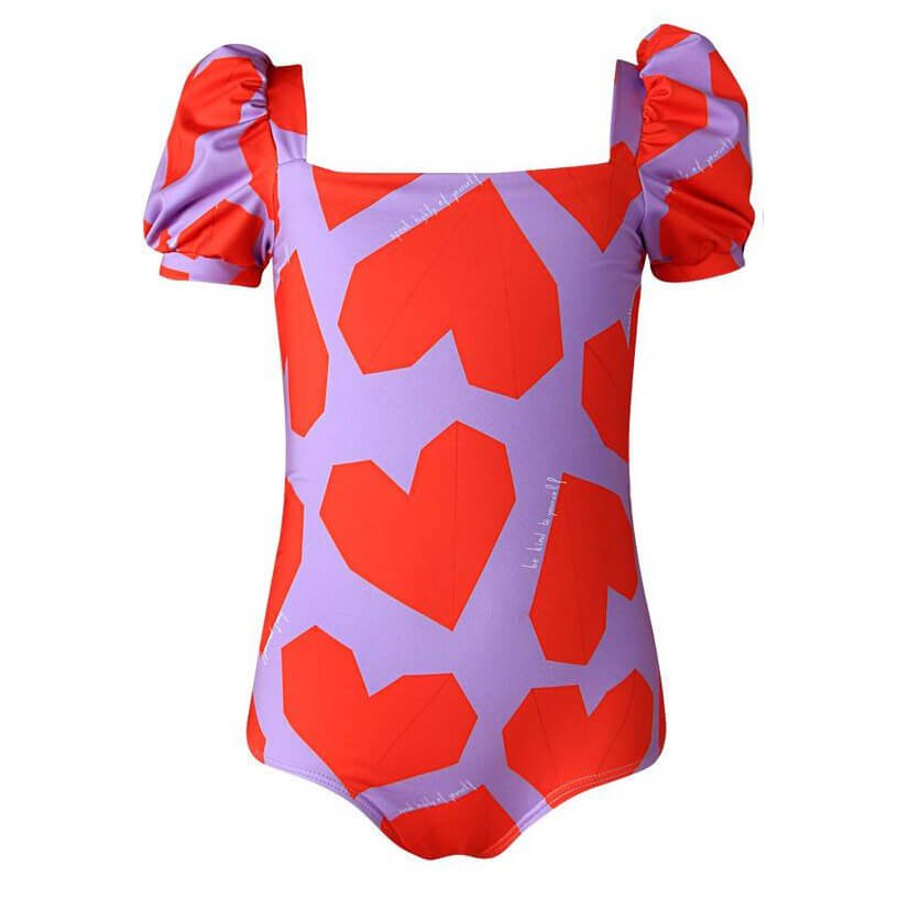 Origami heart patterned puff-sleeve one-piece swimsuit for girls. It is a purple swimsuit with the red hearts. The swimsuit is shown over a white background. 