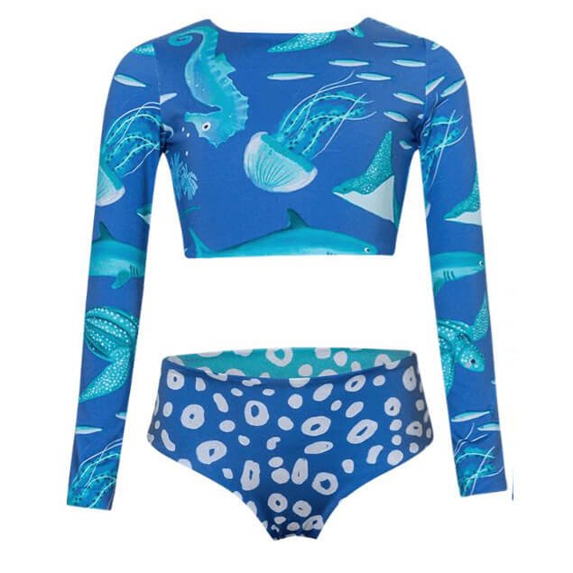 Cute swimsuit featuring a sealife print over the top. A reversible blue and aqua cheetah print over the bottom. The swimsuit is shown over a white background.
