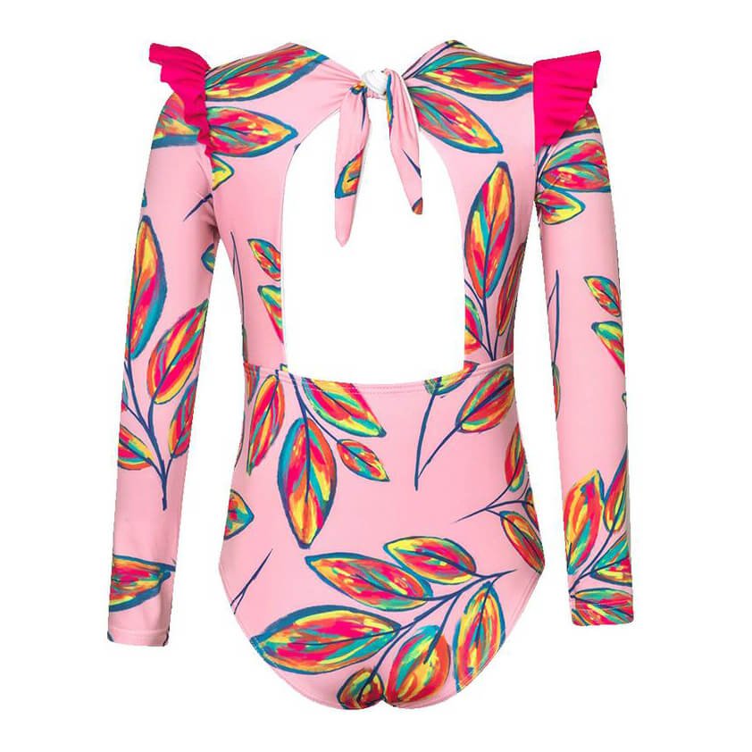 Back of pink one piece swimsuit for girls. It has a colorful leaf pattern all over. It has a cute ruffle "wing" on the shoulder. It is a longsleeve swimsuit shown over a white background. It has a back cutout and bow tie. 