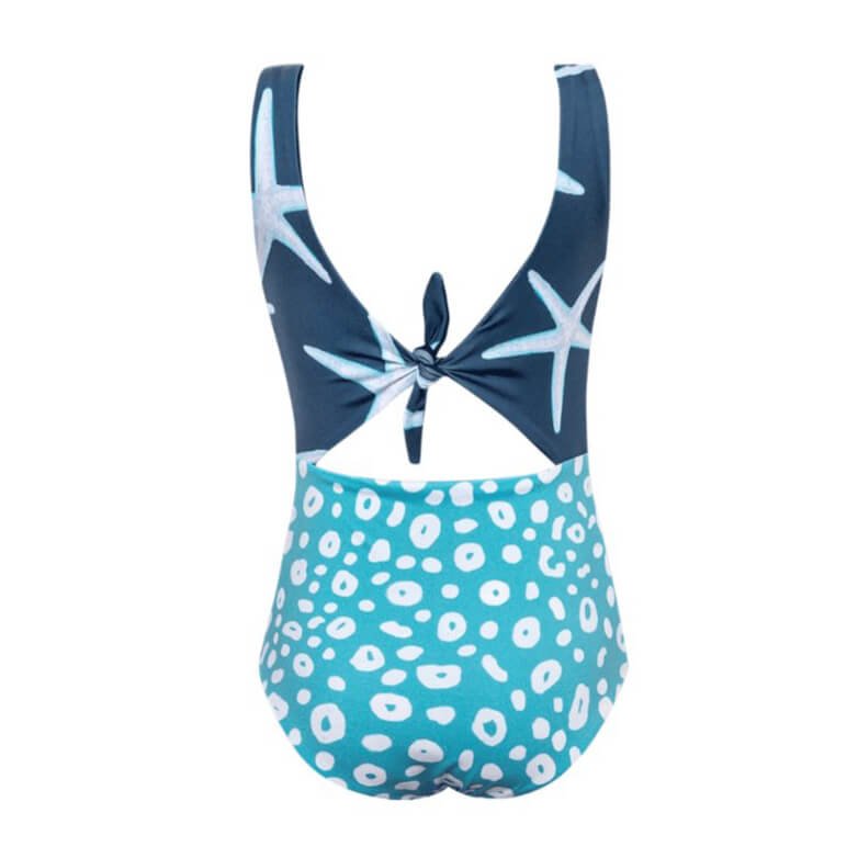 Back of Blue and aqua one piece swimsuit for girls. It has a cutout in the center. The top portion has an adorable seastar pattern. The bottom has a white cheetah print. The swimsuit is shown over a white background. 