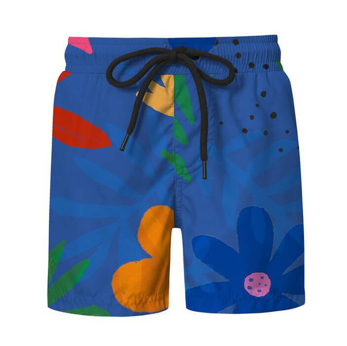Blue swim shorts for boys with a black drawstring and hand drawn flower pattern. The shorts are over a white background.