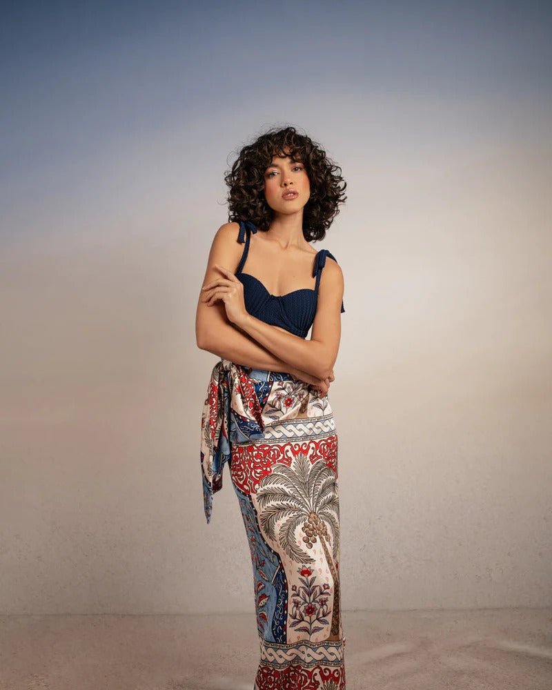 model wearing krystel pampa sarong with Sienna Andina Bikini Top on simple background