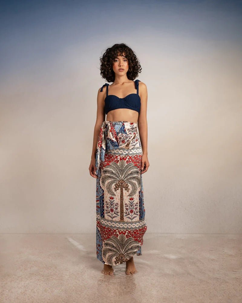 model wearing krystel pampa sarong with Sienna Andina Bikini Top on simple background