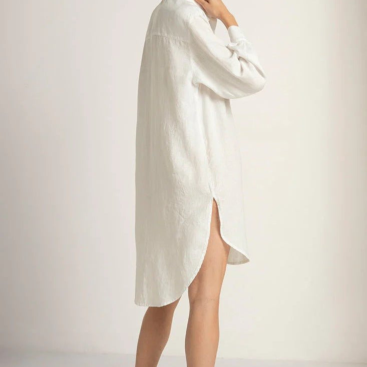 Image of a woman wearing a button down white shirt - available at EVAMAIA boutique.