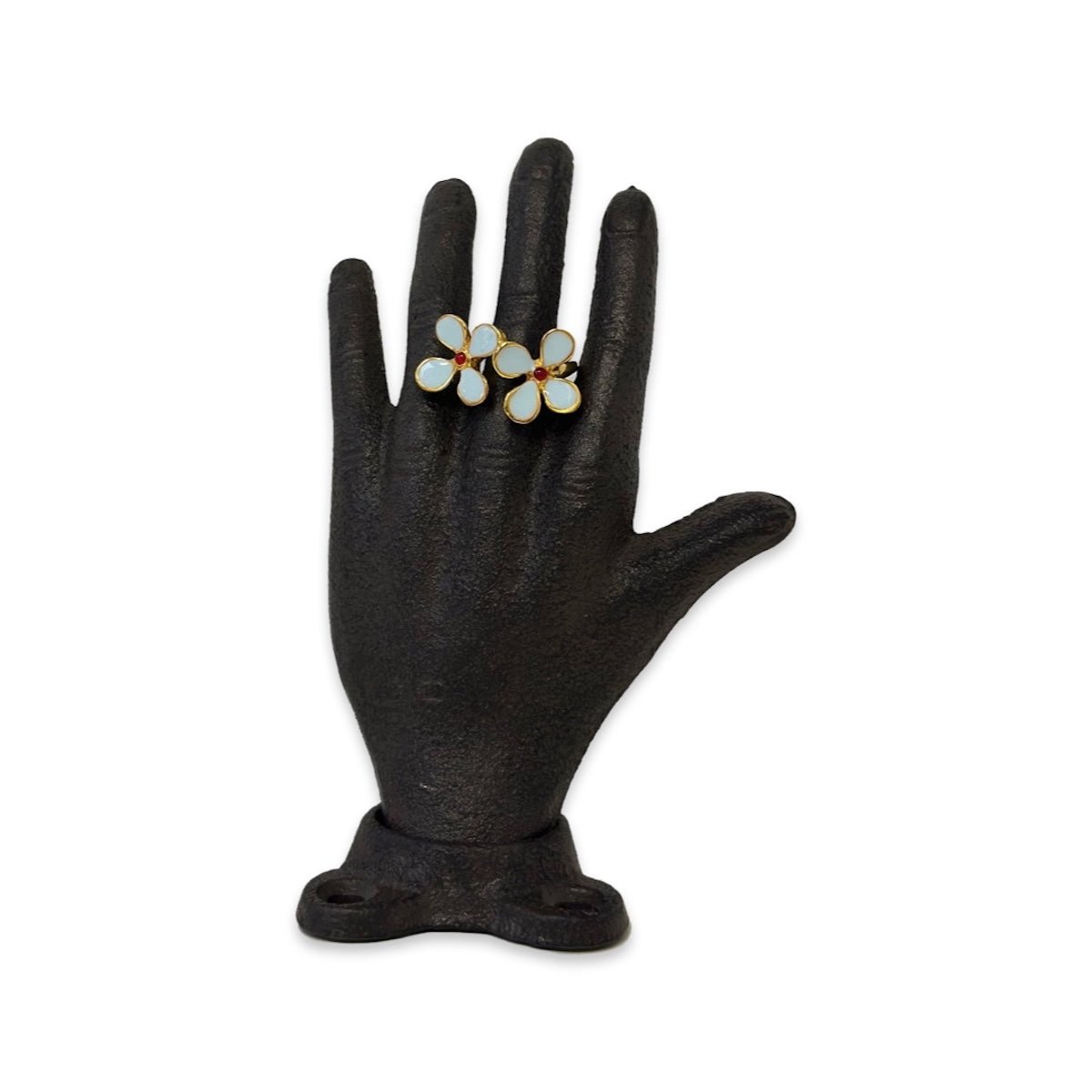 Blue mimosa ring on black hand sculpture on a white background