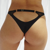 Back of Molly Cutout Bottom in Black on model standing on plain white background