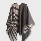Back of grey Natura Poncho on a white background. This poncho features a color block design with leaflike pattern on the darker half. On the lighter half is ti just a small rectangle box of a leaf.