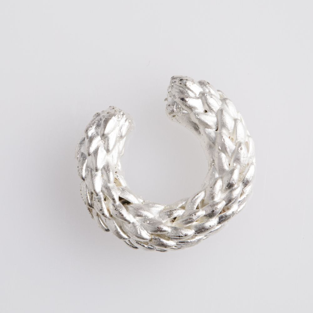 Image of an earcuff in silver. The purpose of this image is to highlight the earcuff by Alma Jewelry.