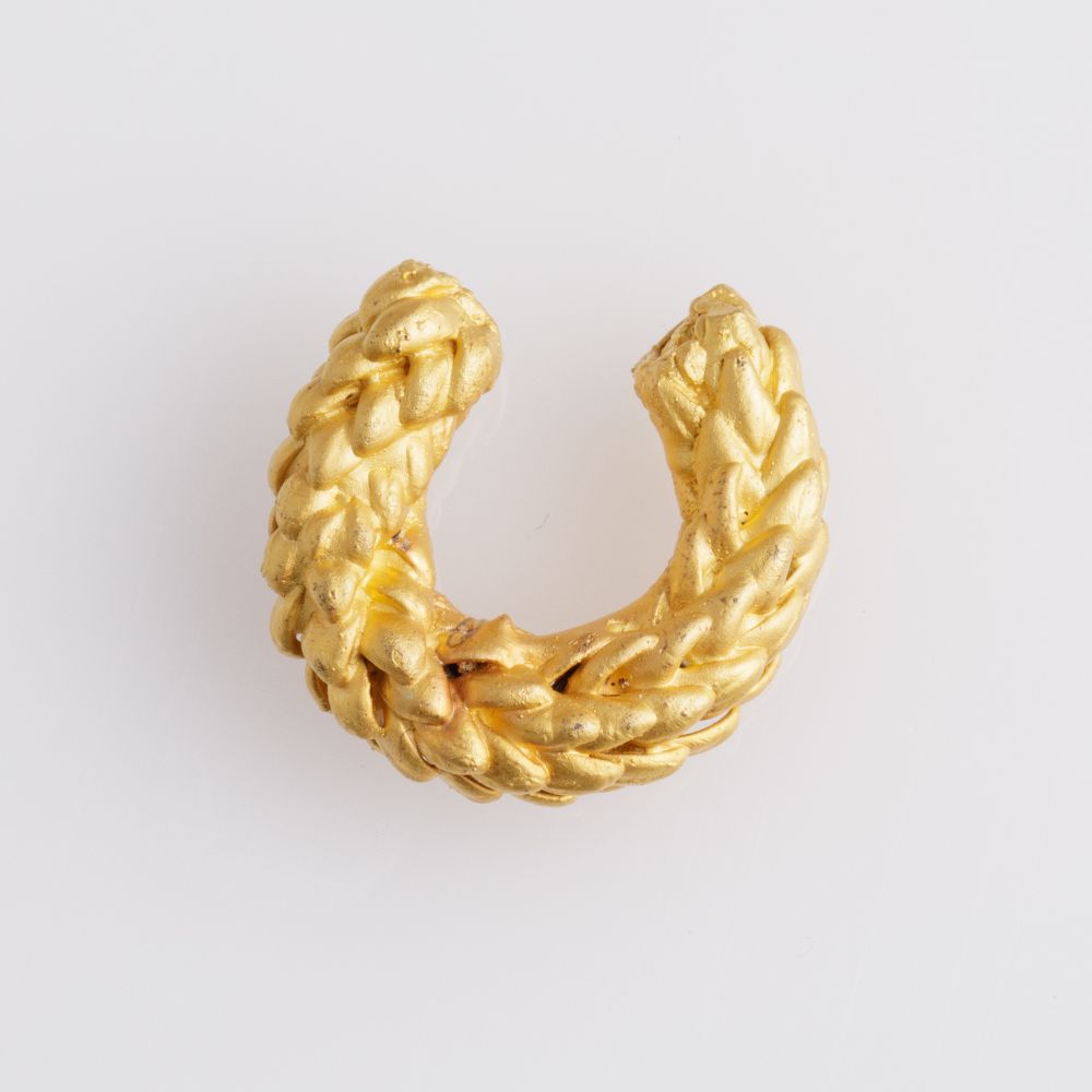 Image of an earcuff in gold. The purpose of this image is to highlight the earcuff by Alma Jewelry.