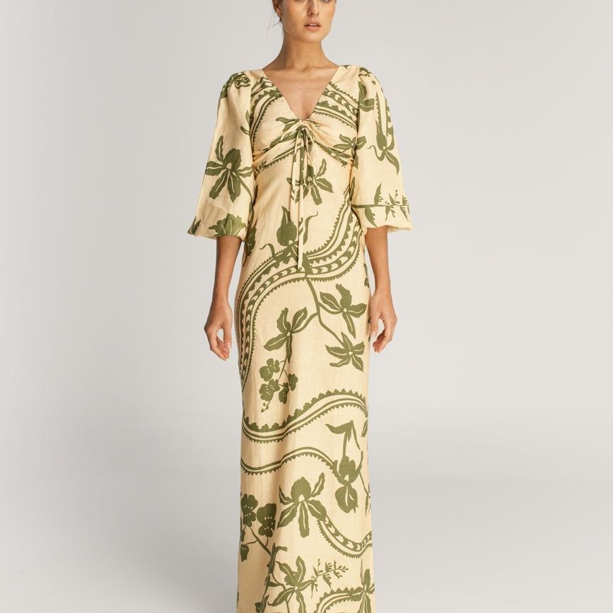 Woman modeling Simone Ivory Emerald Dress on a plain background