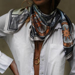 Model wearing the Zodiac Moon Scarf paired with a white longsleeve and a long moon necklace.
