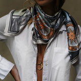 Model wearing the Zodiac Moon Scarf paired with a white longsleeve and a long moon necklace.