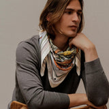 Man modeling brown zodiac scarf wrapped around neck.