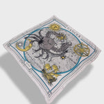 Zodiac scarf for Cancer by Plissé. Off white colored scarf with image of crab, astrological background, sun and moon details. Scarf floating on plain white background.