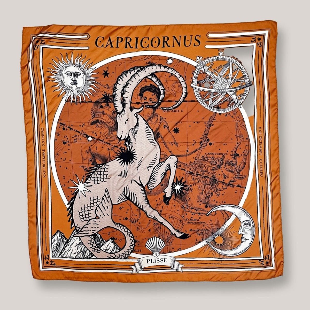 Zodiac Scarf for Capricorn. Image includes mystical goat with starry details, classic sun, moon, and mountains. Scarf on plain white background.