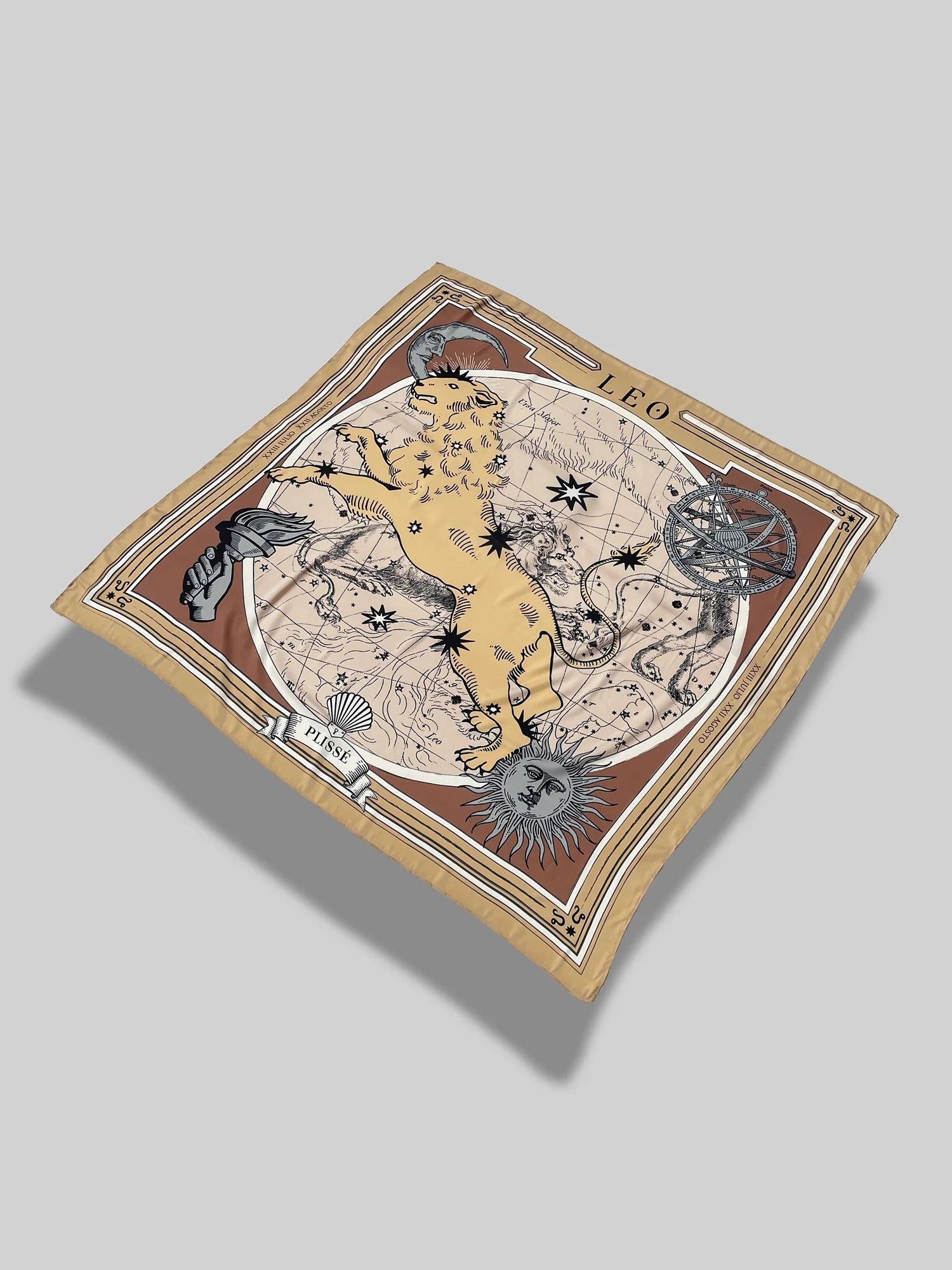 Zodiac Scarf for Leo. Image of fierce lion over astrological background, moon and sun details, in golden tone. Scarf floating on plain white background.
