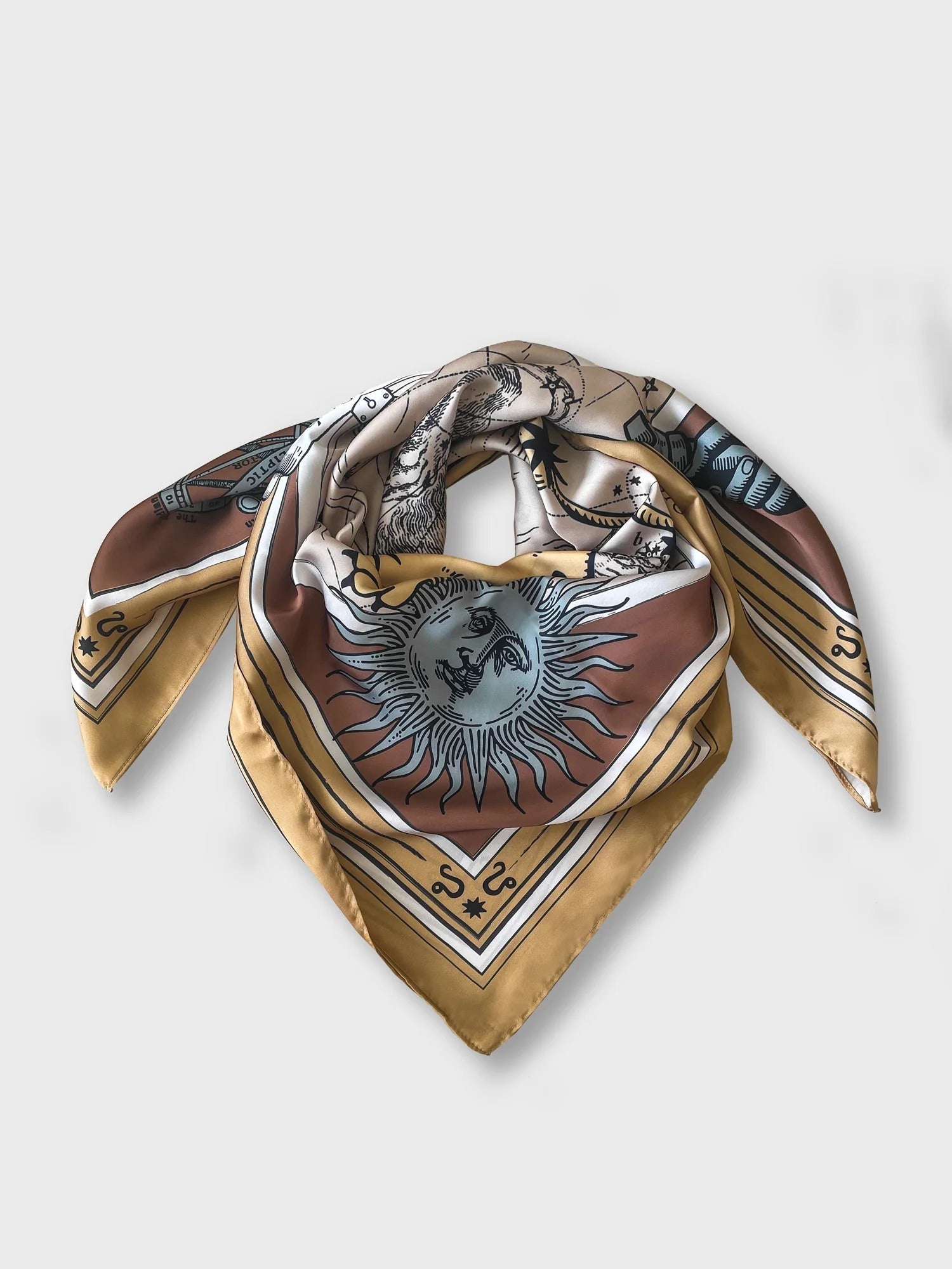 Zodiac Scarf for Leo. Image of fierce lion over astrological background, moon and sun details, in golden tone. Scarf wrapped on surface as if on neck. 