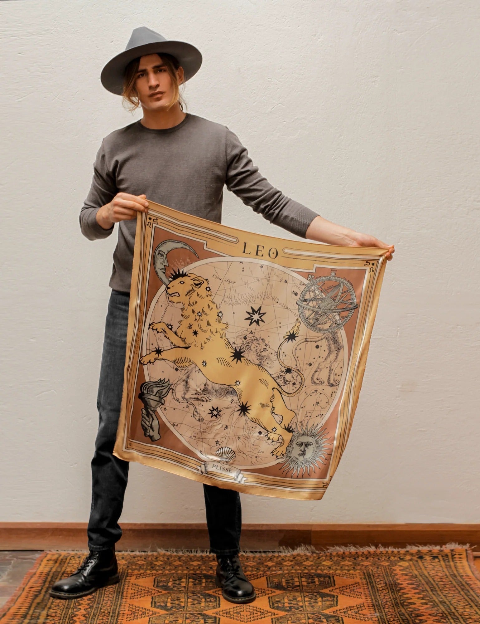 Man holding the Zodiac Scarf for Leo in the air.