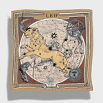 Zodiac Scarf for Leo. Image of fierce lion over astrological background, moon and sun details, in golden tone. Scarf on plain white background. 