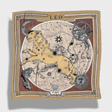 Zodiac Scarf for Leo. Image of fierce lion over astrological background, moon and sun details, in golden tone. Scarf on plain white background. 