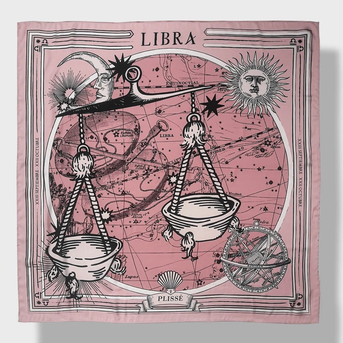 Zodiac Scarf for Libra made by Plissé. Image of scales. It is on top of a astrological background. Details like a white ecliptic, sun, and moon. The scarf is pink with white details displayed on plain background.