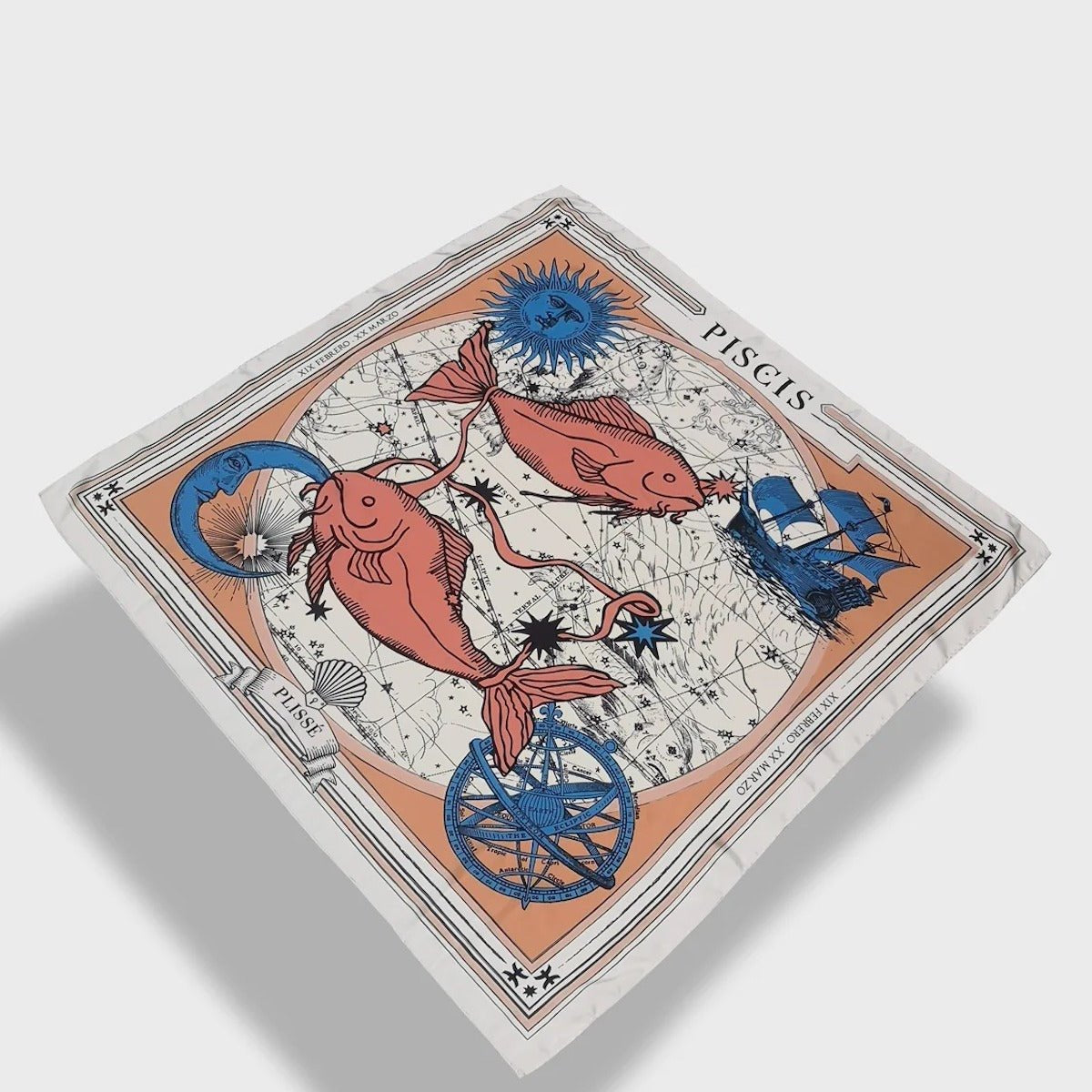 Zodiac Scarf for Pisces made by Plissé. Image of two fish swimming in opposite directions. It is on top of a astrological background. Details of a dark blue ecliptic, sun, moon, and a boat. The scarf is a white with orange and blue details displayed floating on plain background