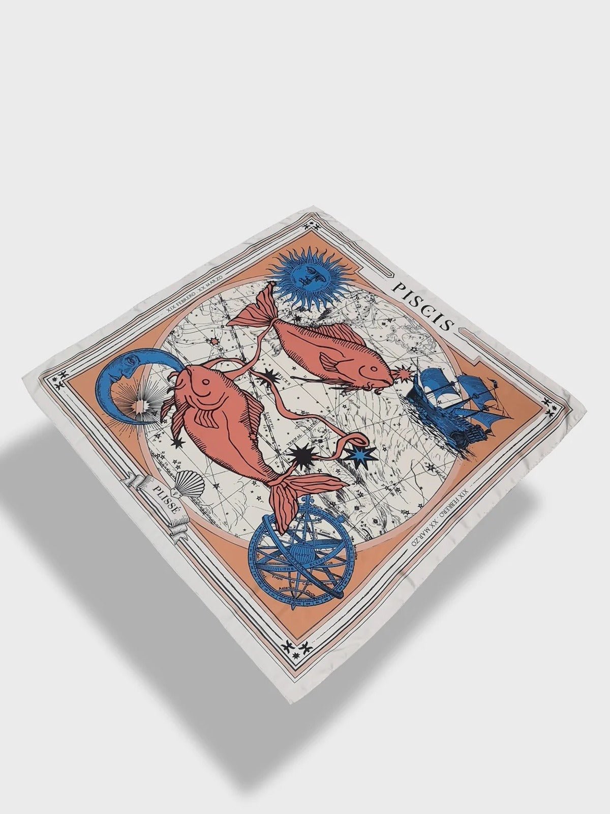 Zodiac Scarf for Pisces made by Plissé. Image of two fish swimming in opposite directions. It is on top of a astrological background. Details of a dark blue ecliptic, sun, moon, and a boat. The scarf is a white with orange and blue details displayed floating on plain background