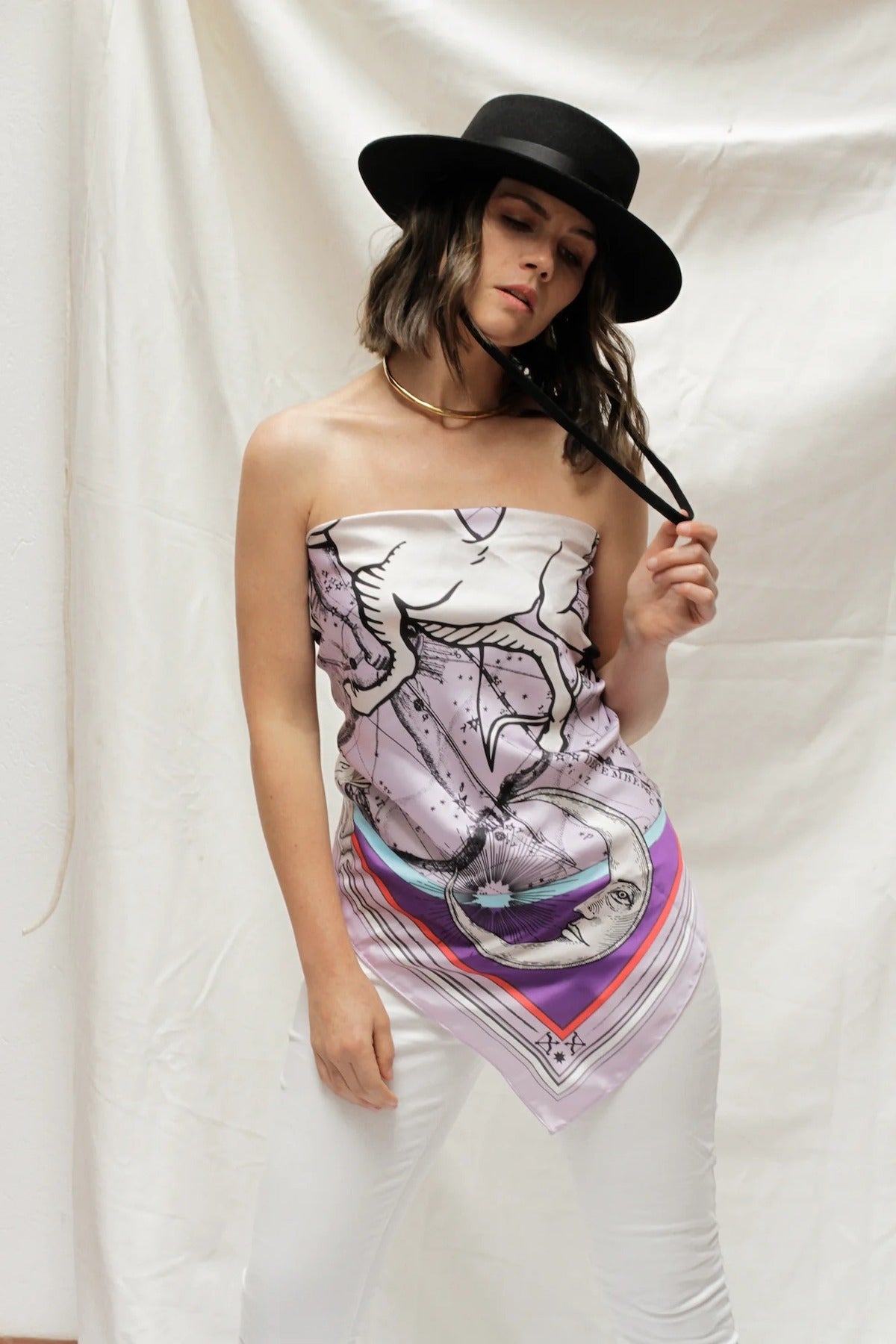 Woman modeling Zodiac Scarf for Sagittarius as strapless top on white background