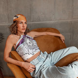Woman on couch posing with Zodiac Scarf for Sagittarius as a top