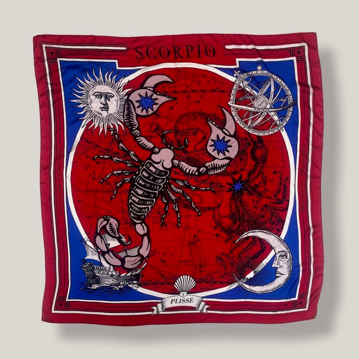 Red scorpio scarf by Plissé. Image of a scorpion, with sun and moon on corners. The scarf is pictured on plain white background.