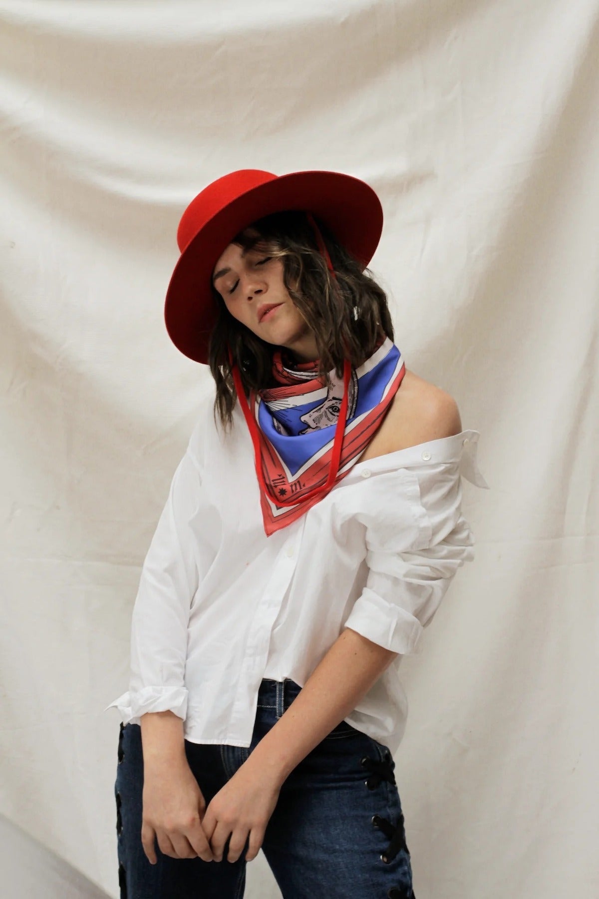 model wearing Zodiac Scarf for Scorpio tied like a triangle on plain background