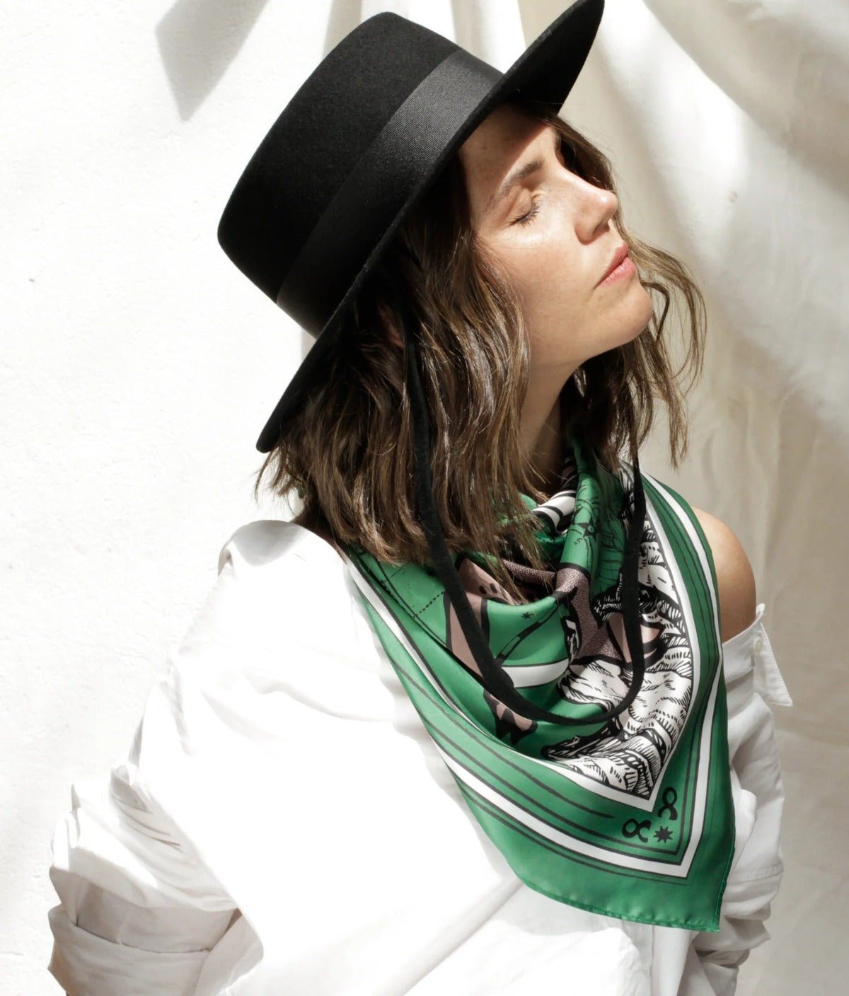 Women modeling Taurus scarf tied around neck