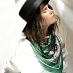 Women modeling Taurus scarf tied around neck