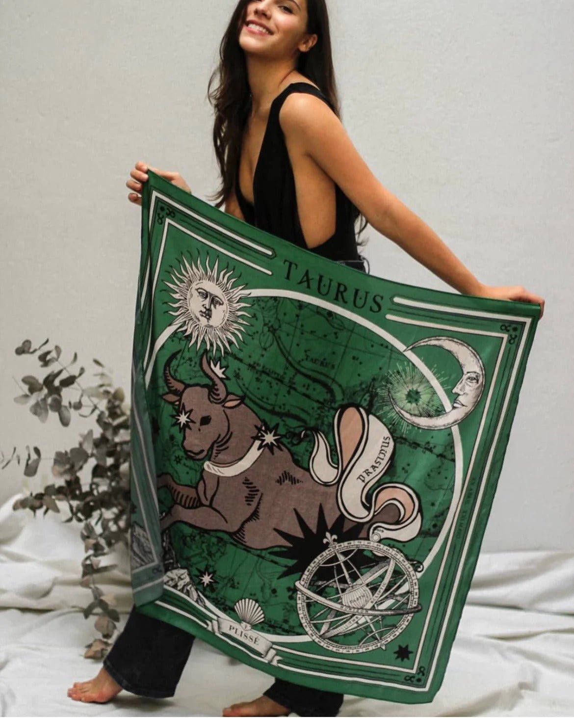 Woman holding Zodiac Scarf for Taurus up in the air