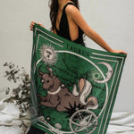 Woman holding Zodiac Scarf for Taurus up in the air