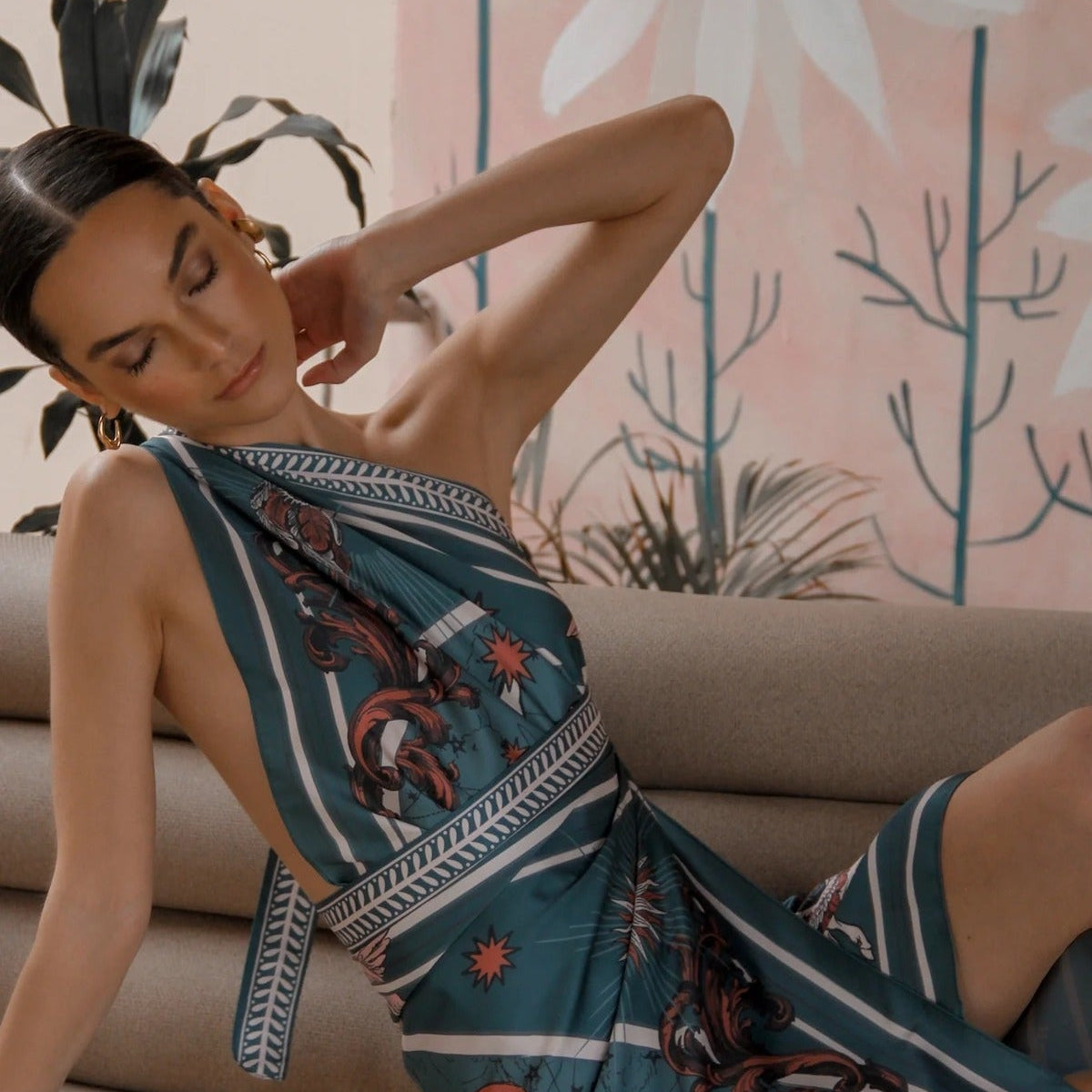 Woman modeling Air Zodiac Wrap Dress laying on couch
